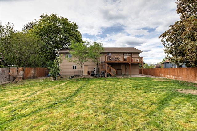 back of house with a deck and a yard