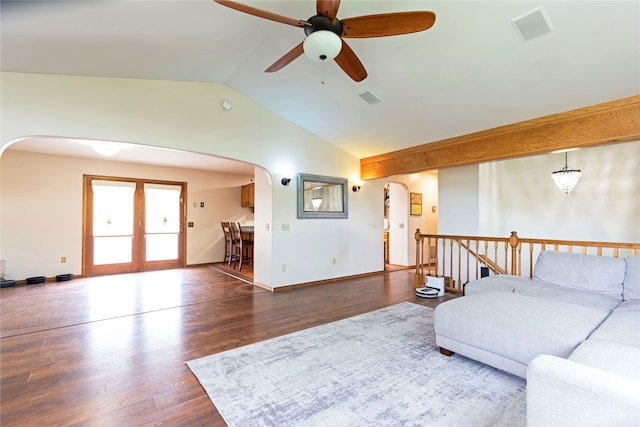 living room featuring dark hardwood / wood-style flooring, ceiling fan with notable chandelier, and lofted ceiling