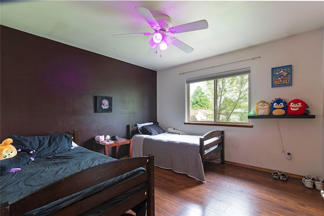 bedroom featuring dark hardwood / wood-style flooring and ceiling fan