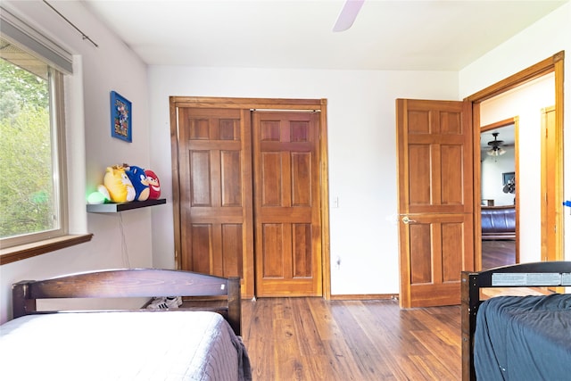 bedroom with ceiling fan and dark hardwood / wood-style flooring