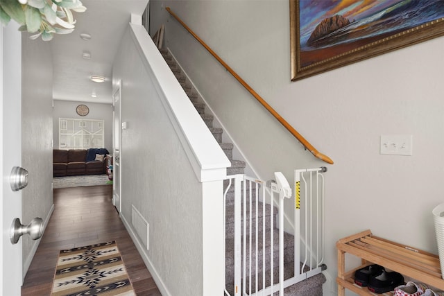 staircase with dark hardwood / wood-style floors