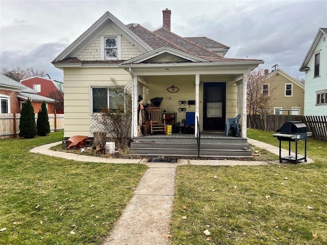 bungalow-style home featuring a front lawn