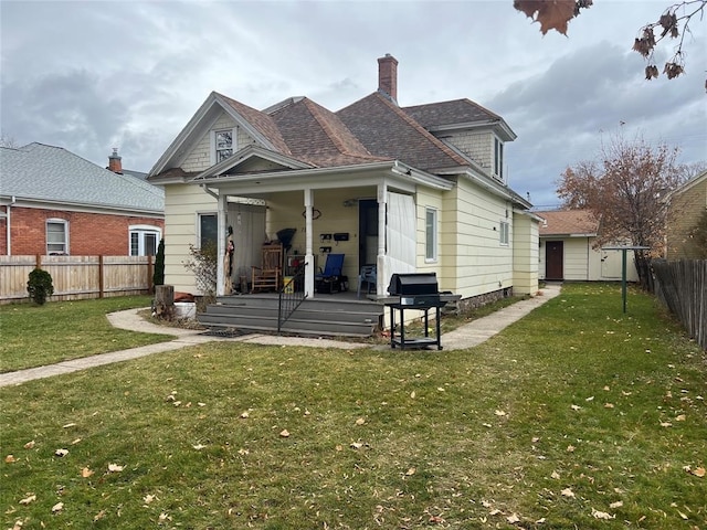 back of property featuring a yard