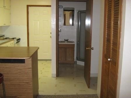 corridor with tile floors and sink