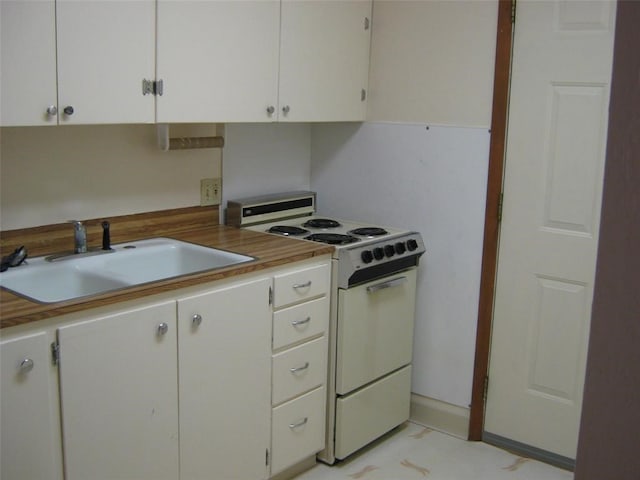 kitchen featuring white cabinetry and white range with gas stovetop