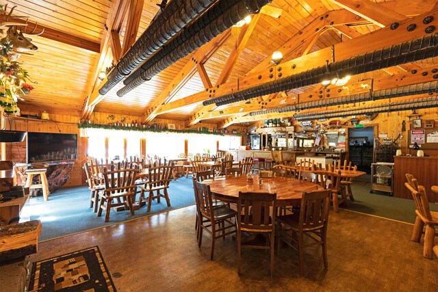 283 Lost Trail Hot Springs Rd, Sula, MT 59871 - dining room with wooden ceiling, carpet floors, and vaulted ceiling with beams