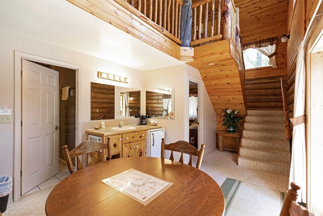 283 Lost Trail Hot Springs Rd, Sula, MT 59871 - dining space featuring light carpet, sink, and log walls