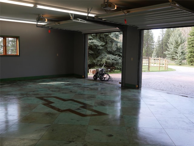 41698 Canal Rd, Polson, MT 59860 - garage featuring baseboards and a garage door opener