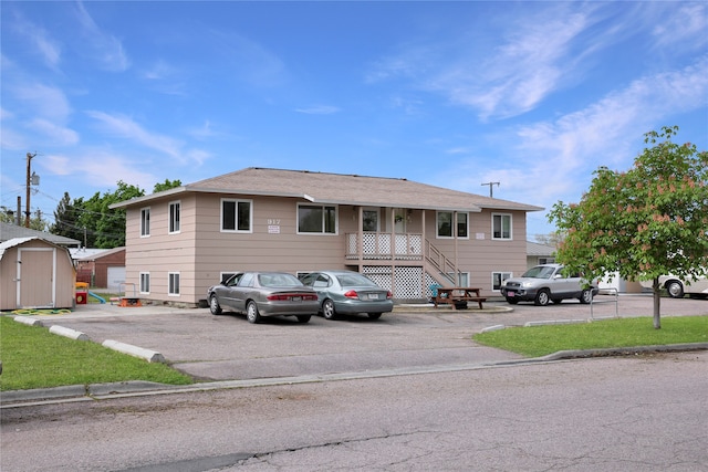 view of front of home featuring a storage shed