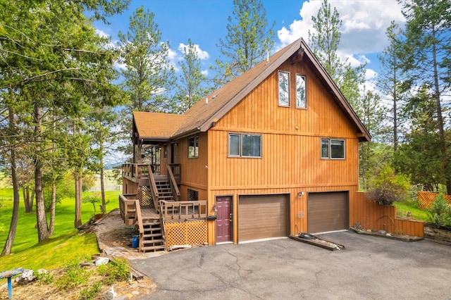 exterior space featuring a garage and a wooden deck