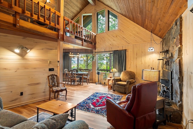 living room with high vaulted ceiling, wood walls, hardwood / wood-style flooring, and wooden ceiling