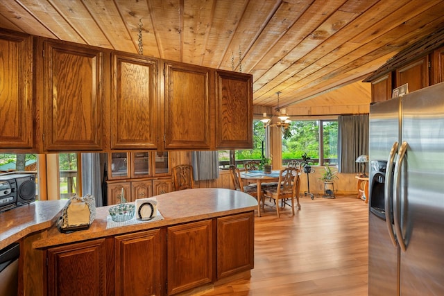 kitchen with appliances with stainless steel finishes, a wealth of natural light, wood ceiling, and light wood-type flooring