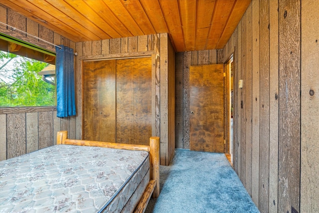 unfurnished bedroom featuring wood walls and wood ceiling