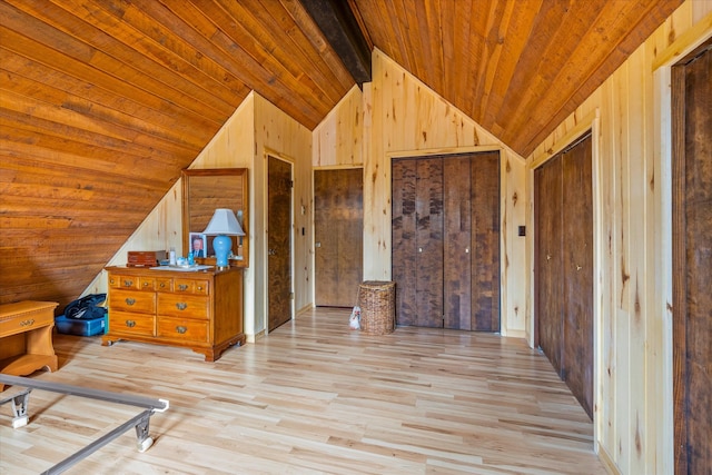 unfurnished bedroom with vaulted ceiling, wooden walls, light hardwood / wood-style flooring, and wooden ceiling