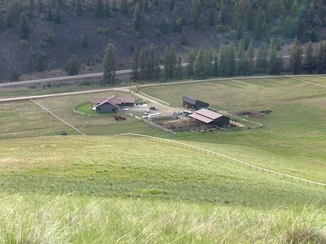 birds eye view of property with a rural view