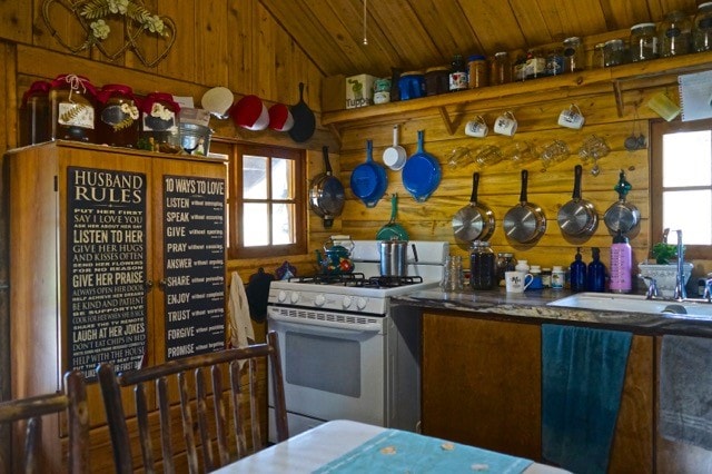 kitchen with vaulted ceiling, wood ceiling, white gas stove, and a healthy amount of sunlight