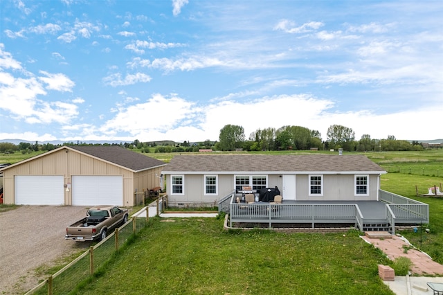 single story home featuring a front yard, a garage, and a deck