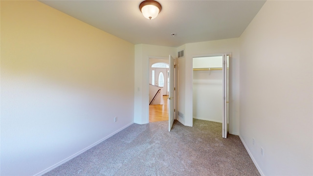 unfurnished bedroom featuring a closet and carpet floors