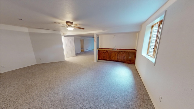 interior space featuring ceiling fan and sink