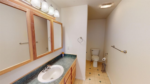 bathroom featuring tile flooring, large vanity, and toilet