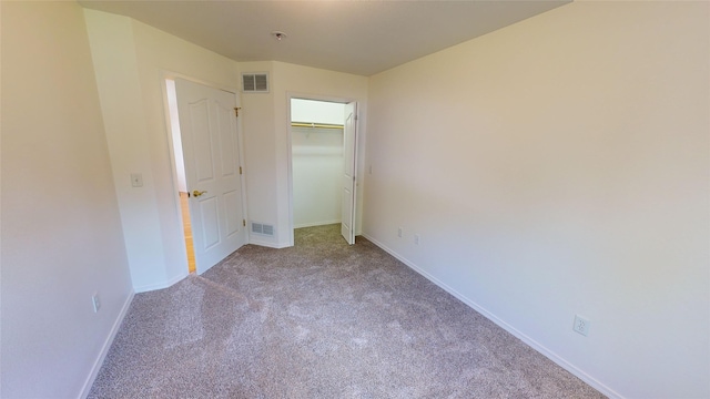 unfurnished bedroom featuring carpet flooring and a closet