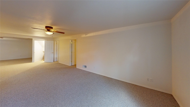 unfurnished room featuring ceiling fan and carpet floors