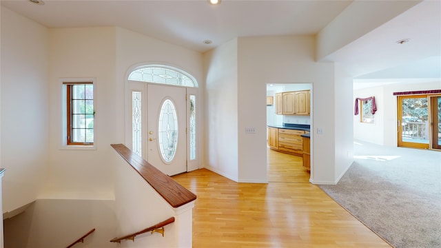 foyer featuring light colored carpet