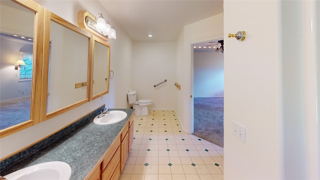 bathroom with tile floors, dual vanity, and toilet