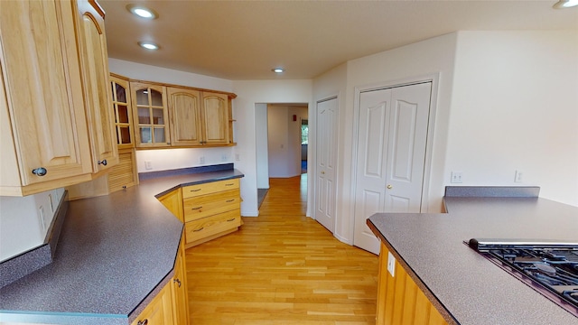 kitchen with light brown cabinets, light hardwood / wood-style floors, and gas cooktop