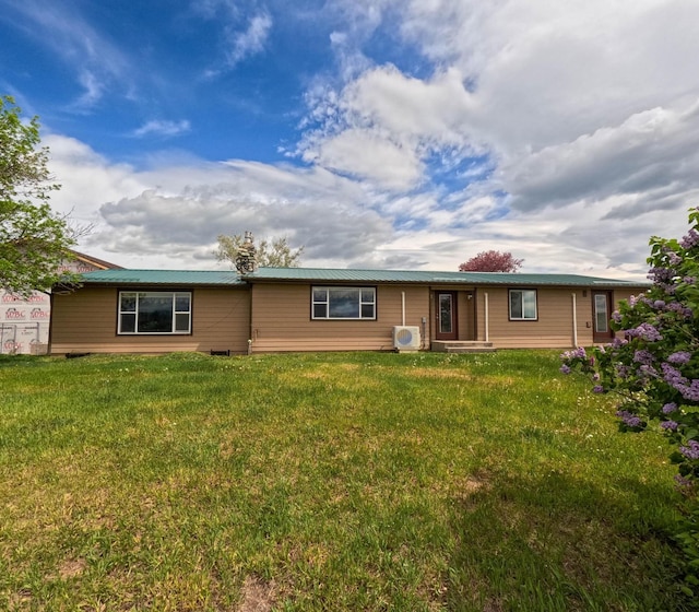 back of house with a yard and ac unit