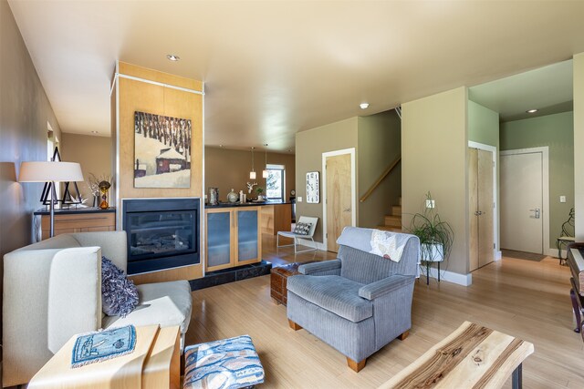 living room with light hardwood / wood-style floors and a fireplace