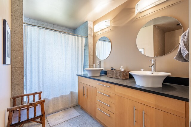 bathroom featuring double vanity and tile floors