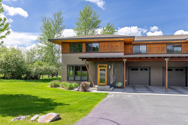 view of front of house with a garage and a front lawn