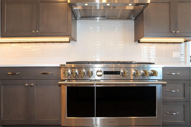 198 Blaine Lakeshore Dr, Kalispell, MT 59901 - kitchen featuring tasteful backsplash, custom exhaust hood, light countertops, and range with two ovens