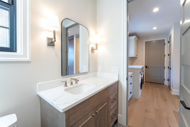 198 Blaine Lakeshore Dr, Kalispell, MT 59901 - bathroom with toilet, recessed lighting, vanity, and wood finished floors