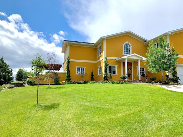 view of front facade featuring a garage and a front lawn