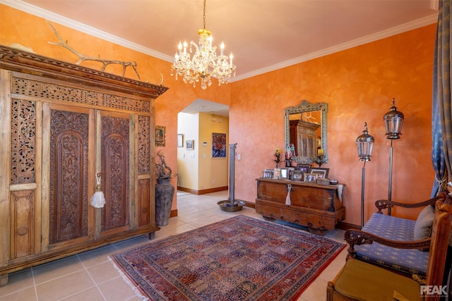 tiled foyer with ornamental molding and a notable chandelier