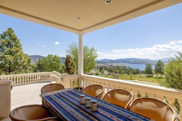 balcony featuring a water and mountain view