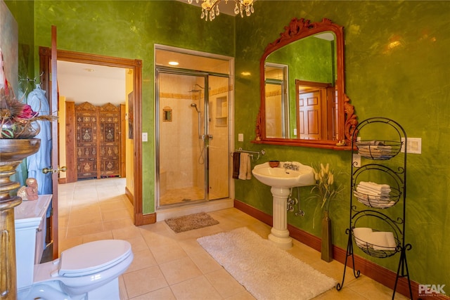 bathroom featuring walk in shower, tile patterned floors, toilet, and a notable chandelier