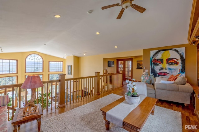 living room with wood-type flooring and vaulted ceiling