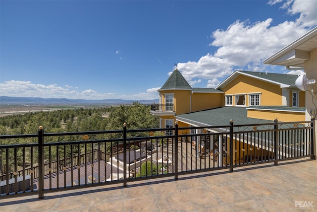 exterior space featuring a balcony and a mountain view