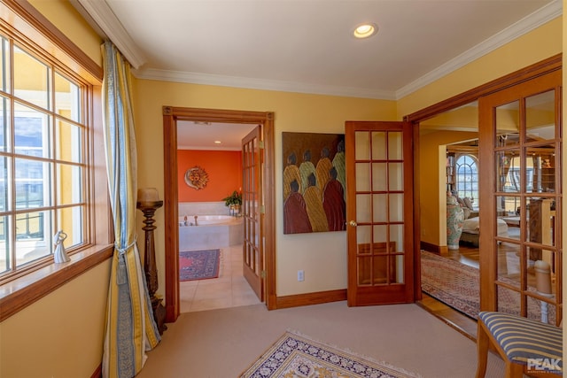 corridor featuring ornamental molding, light carpet, and french doors