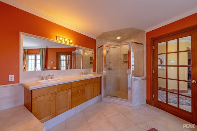 bathroom with crown molding, vanity, and an enclosed shower