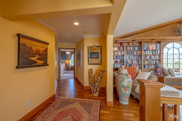 hall featuring ornamental molding, vaulted ceiling, and wood-type flooring