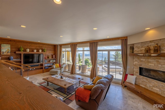 living room featuring a fireplace and rustic walls