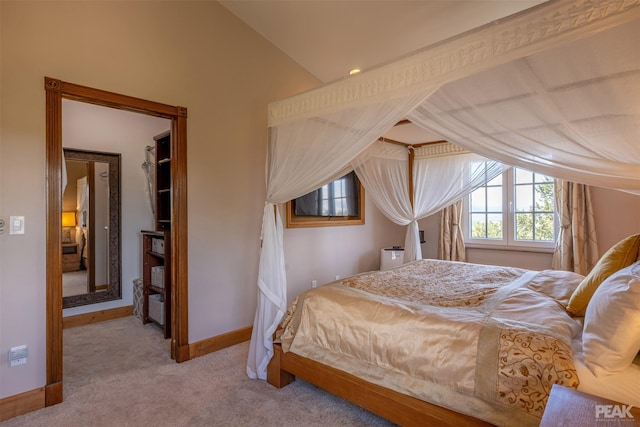 bedroom with vaulted ceiling and light carpet