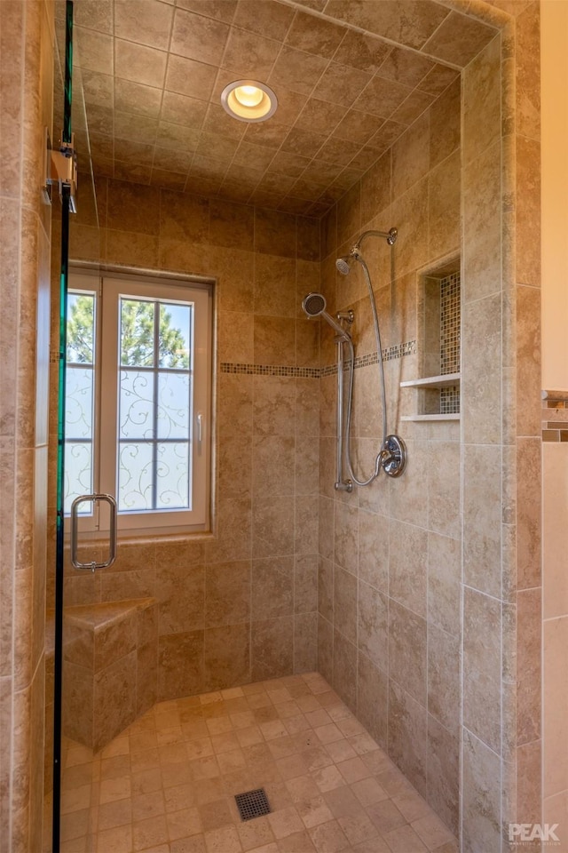 bathroom featuring a tile shower