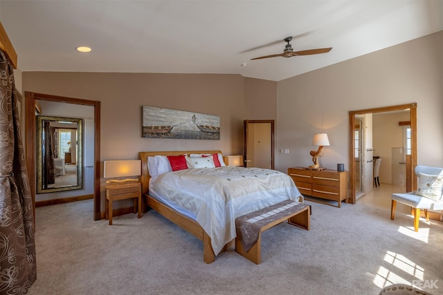 bedroom with vaulted ceiling, light colored carpet, and ceiling fan