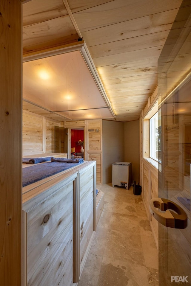 hallway with wood ceiling and wood walls