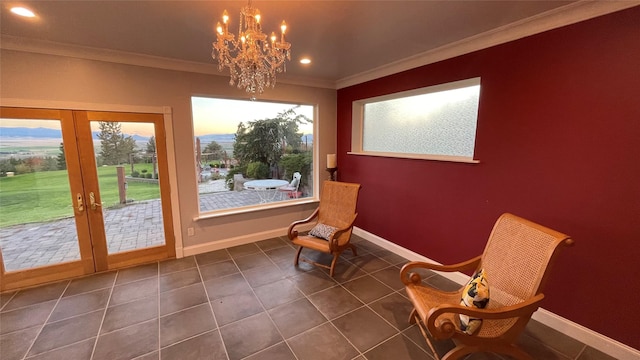 sitting room featuring crown molding, plenty of natural light, dark tile patterned flooring, and french doors